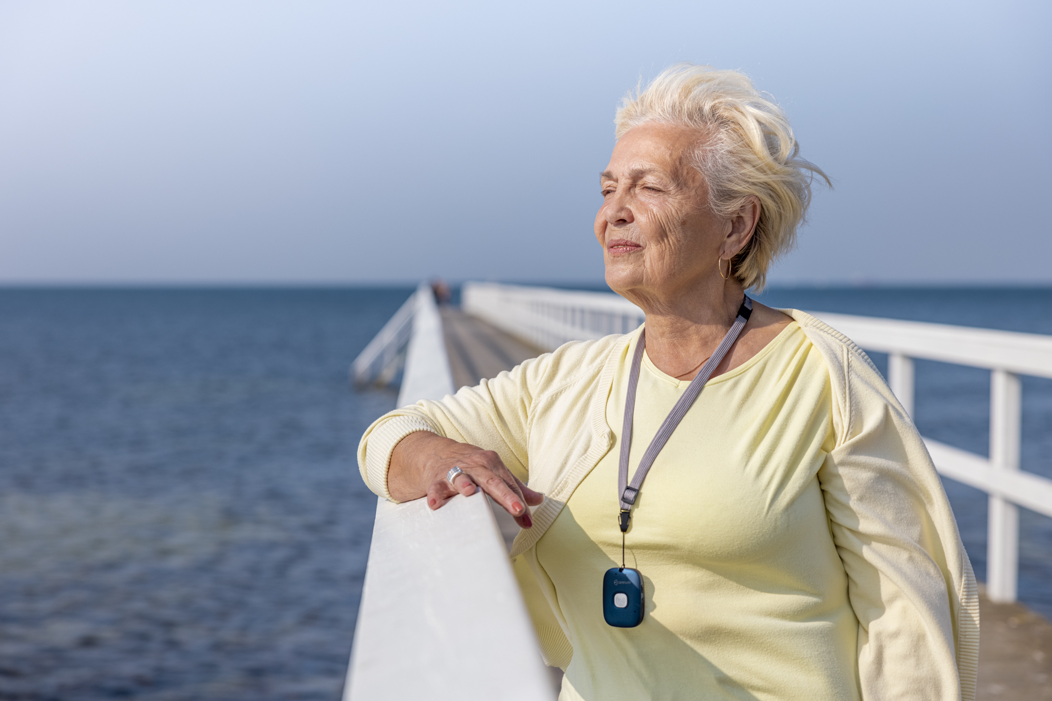 mevrouw met een alarmeringsknop om haar hals buiten